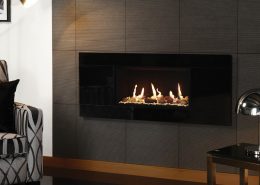 Gazco Studio 1 Glass gas fire Conventional Flue, with Pebble and White Stone fuel bed and Black Reeded lining with Linea Negro Tile Surround